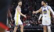 Klay Thompson and guard Stephen Curry high five