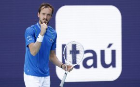 Daniil Medvedev reacting with a fist pump after a play during a tennis match.