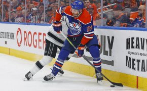 Edmonton Oilers forward Leon Draisaitl battles for a loose puck with Los Angeles Kings defensemen Matt Roy