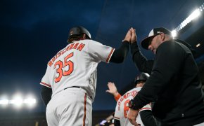 Baltimore Orioles catcher Adley Rutschman celebrates scoring a run with teammates