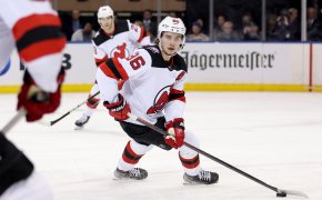New Jersey Devils center Jack Hughes controls the puck against the New York Rangers