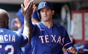 Texas Rangers designated hitter Brad Miller high-fiving teammates