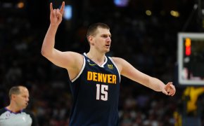 Nikola Jokic holding up two fingers and calling out play