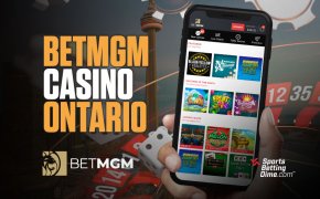 BetMGM Casino Ontario hand holding mobile phone with games