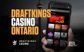 DraftKings Casino Ontario hand holding mobile phone CN Tower