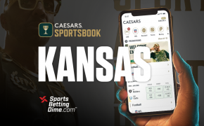 Caesars Sportsbook Kansas sports betting hand holding mobile phone with app