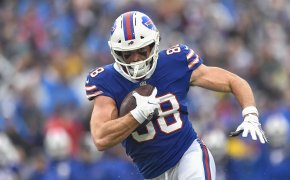 Buffalo Bills tight end Dawson Knox running with the ball during an NFL football game.