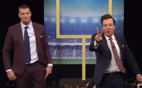 Rob Gronkowski and Jimmy Fallon holding up two fingers in suits