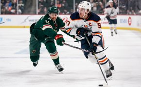 Edmonton Oilers forward Connor McDavid skates with the puck against Minnesota Wild forward Joel Eriksson Ek
