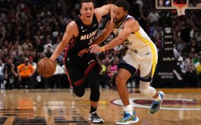 Miami Heat guard Duncan Robinson drives around Golden State Warriors guard Stephen Curry