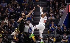 New York Knicks guard Jalen Brunson shoots over Golden State Warriors guard Stephen Curry