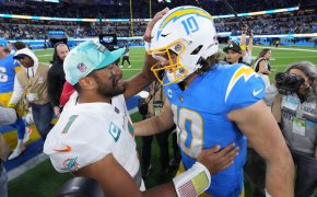 Miami Dolphins quarterback Tua Tagovailoa and Los Angeles Chargers quarterback Justin Herbert shake hands