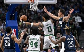 Boston Celtics forward Jayson Tatum goes for a layup against Dallas Mavericks defenders