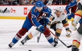 Colorado Avalanche center Nathan MacKinnon controls the puck under pressure from Vegas Golden Knights