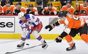 New York Rangers left wing Artemi Panarin is defended by Philadelphia Flyers right wing Wade Allison