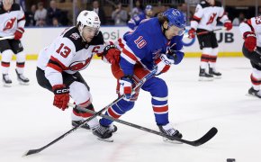 New York Rangers left wing Artemi Panarin fights for the puck against New Jersey Devils center Nico Hischier