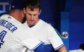 Toronto Blue Jays manager John Schneider hugging starting pitcher Chris Bassitt