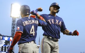 Texas Rangers left fielder Robbie Grossman celebrates with Josh Jung