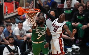 Celtics Jaylen Brown dunking on Bam Adebayo of Heat