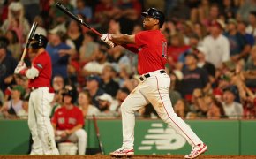 Boston Red Sox third baseman Rafael Devers hitting a double