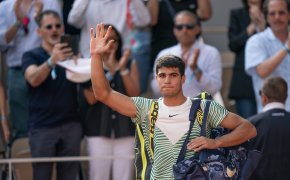 Carlos Alcaraz salutes the crowd at Roland Garros.