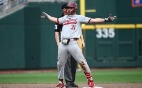 Carter Graham celebrates at second base with arms wide out after hit vs Wake Forest