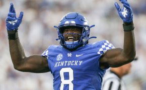 Kentucky Wildcats Football player Octavious Oxendine arms up in air