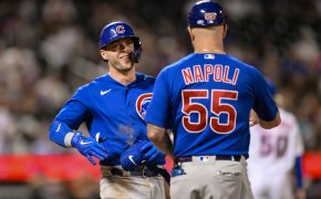 Chicago Cubs second baseman Nico Hoerner celebrating with first-base coach