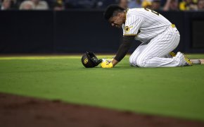 San Diego Padres left fielder Juan Soto kneels on the grass