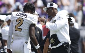 Colorado Buffaloes head coach Deion Sanders talks to quarterback Shedeur Sanders (2) after a touchdown in the fourth quarter against the TCU Horned Frogs.