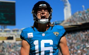 Jacksonville Jaguars quarterback Trevor Lawrence (16) yells after wide receiver Christian Kirk (13), not shown, caught a pass for a touchdown