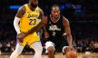 LA Clippers forward Kawhi Leonard moves the ball against Los Angeles Lakers forward LeBron James