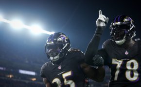 Baltimore Ravens running back Gus Edwards (35) celebrates a touchdown run