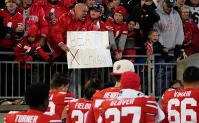 Ohio State Buckeyes fan holding a sign reading 