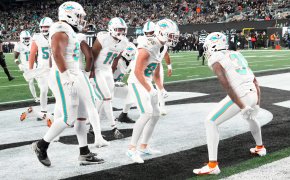 Miami Dolphins running back Raheem Mostert (31) joins his teammates in celebrating his second half touchdown