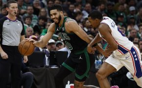 Boston Celtics forward Jayson Tatum tries to hold off Philadelphia 76ers guard De'Anthony Melton