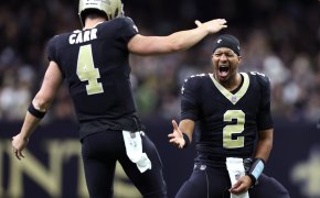 New Orleans Saints QBs Winston and Carr celebrating high five black and gold jerseys