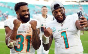 Miami Dolphins quarterback Tua Tagovailoa and running back Raheem Mostert celebrate after defeating the New York Jets at Hard Rock Stadium