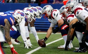 The defensive line of the Buffalo Bills lines up against the offensive line of the New England Patriots.