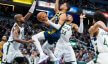 Indiana Pacers guard Tyrese Haliburton drives against several Milwaukee Bucks defenders