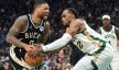 Milwaukee Bucks guard Damian Lillard and Boston Celtics forward Oshae Brissett battle for the ball