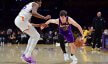 Los Angeles Lakers guard Austin Reaves drives past Phoenix Suns forward Kevin Durant