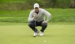 Rory McIlroy lines up a putt