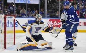 Toronto Maple Leafs forward Auston Matthews tries to deflect a puck against St. Louis Blues goaltender Jordan Binnington