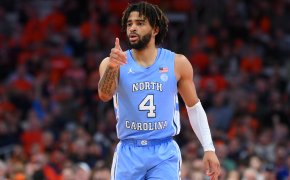 North Carolina Tar Heels college basketball player RJ Davis pointing blue jersey