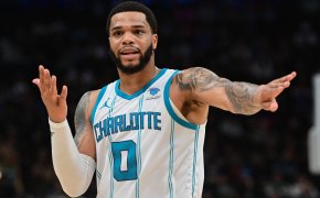 Charlotte Hornets player Miles Bridges pointing white and blue jersey
