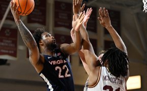 Virginia Cavaliers forward Jordan Minor shoots over two Boston College Eagles defenders