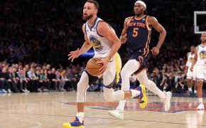 Golden State Warriors guard Stephen Curry drives to the basket as New York Knicks forward Precious Achiuwa looks on