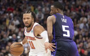New York Knicks guard Jalen Brunson dribbles the basketball against Sacramento Kings guard De'Aaron Fox