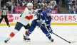 Florida Panthers forward Sam Reinhart pushes on Toronto Maple Leafs forward Auston Matthews